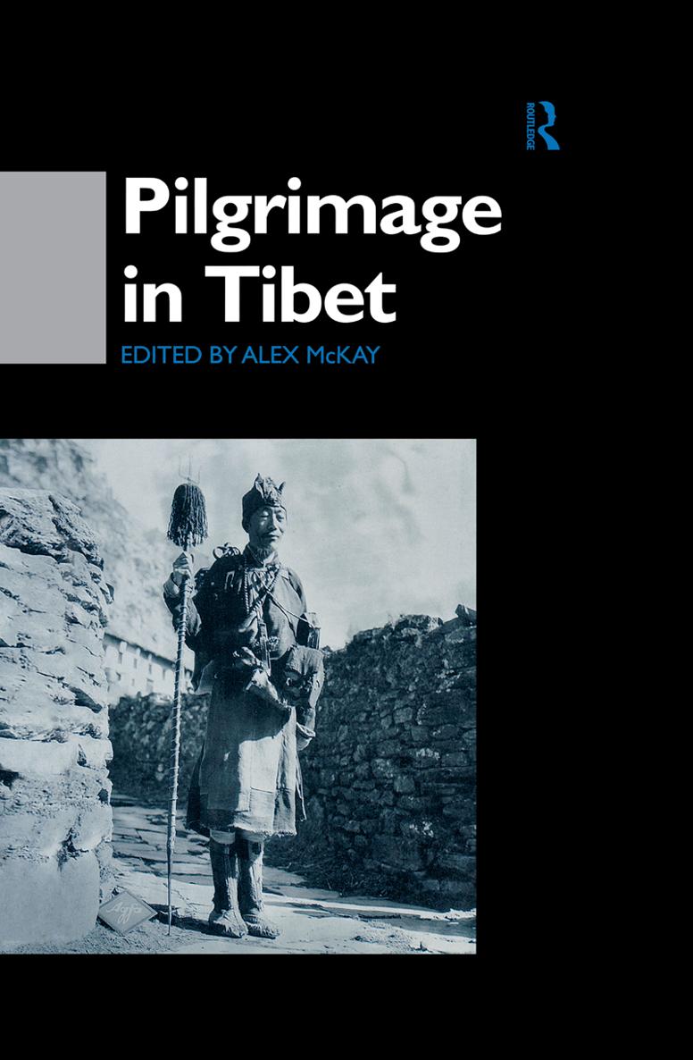 PILGRIMAGE IN TIBET A Tibetan pilgrim approaching the giant flagpole at - photo 1