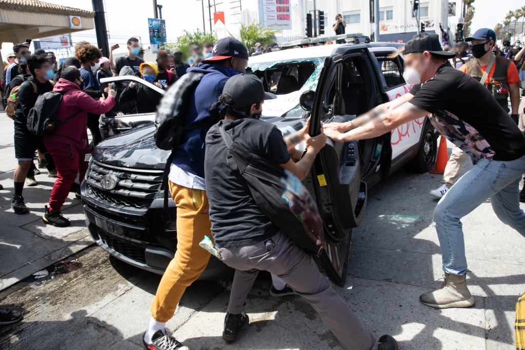 LOS ANGELES MAY 30 2020 Police car attacked during the protest march against - photo 2