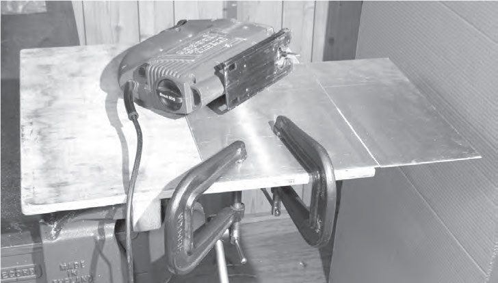 Photo Being used to hold a sheet of metal while it is being cut using a jig - photo 4