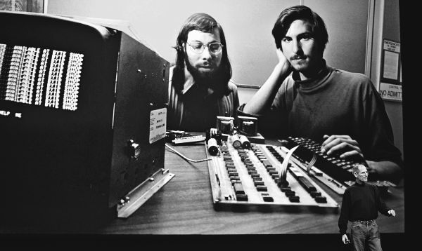 Steve Jobs stands dwarfed by his own history speaking before a 1976 photo of - photo 4