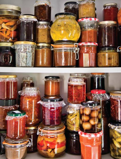 Well-stocked shelves featuring jars of jam jelly marmalade chutney cordial - photo 4