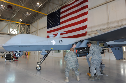 Air Force ordnance personnel load a Hellfire missile on an MQ-9 Reaper unmanned - photo 5