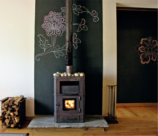 A traditional bukhari fireplace in one of the villas set against a wall - photo 13