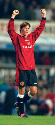 Beckham celebrates to the crowd after scoring a goal during the Premiership - photo 1