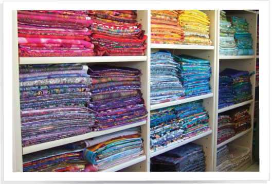 Larger foldable cuts of fabric are organized by color on shelves in my design - photo 7