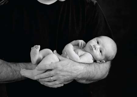 IMAGE 1-1 An infant in Dads arms This studio photograph created on a dark - photo 5