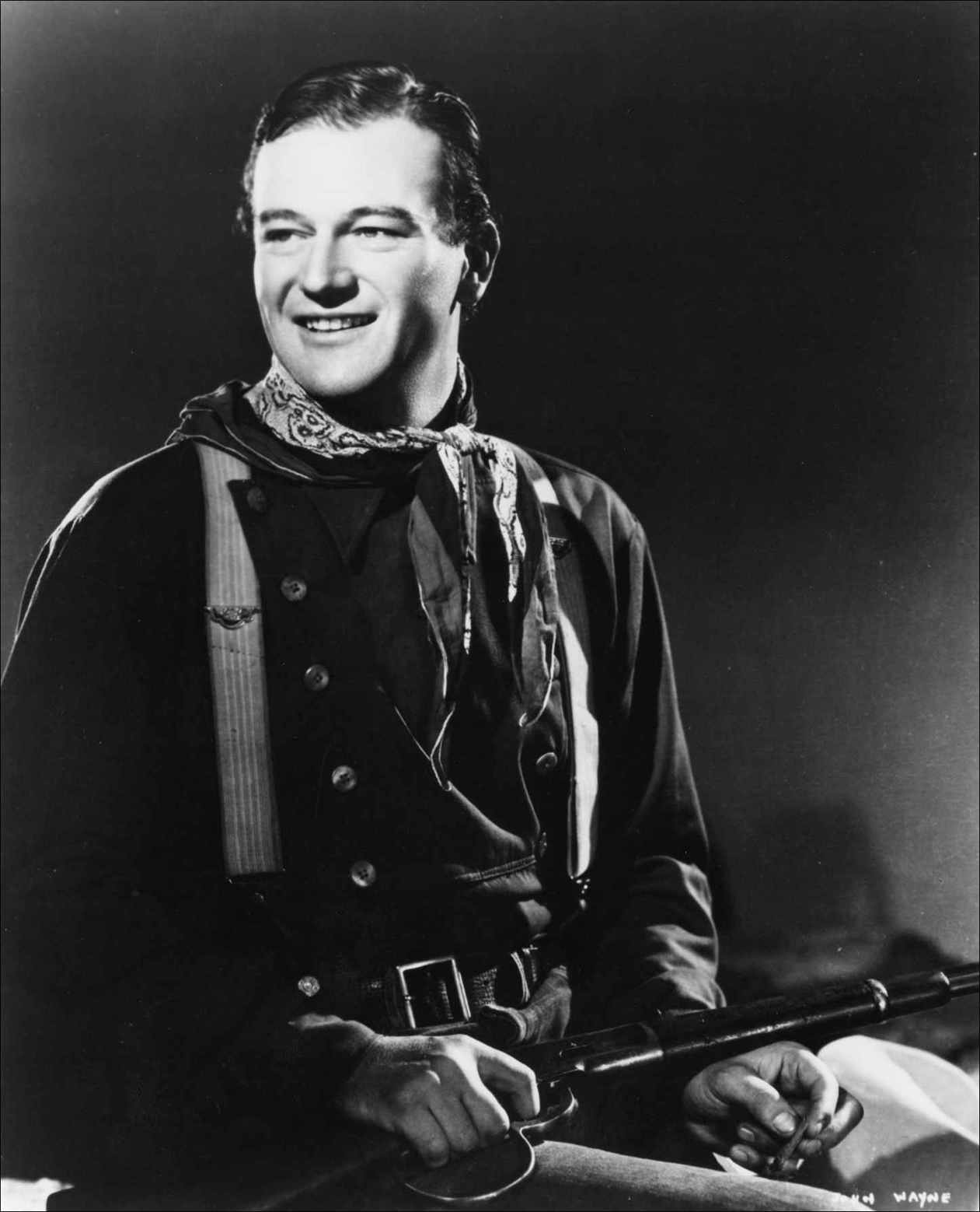 John Wayne with the customized sawed-off Winchester he twirls in his - photo 3