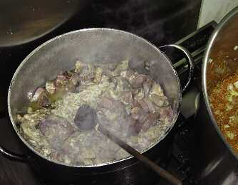 Sheep offal stewed in a huge casserole with lots of onions a few herbs olive - photo 5