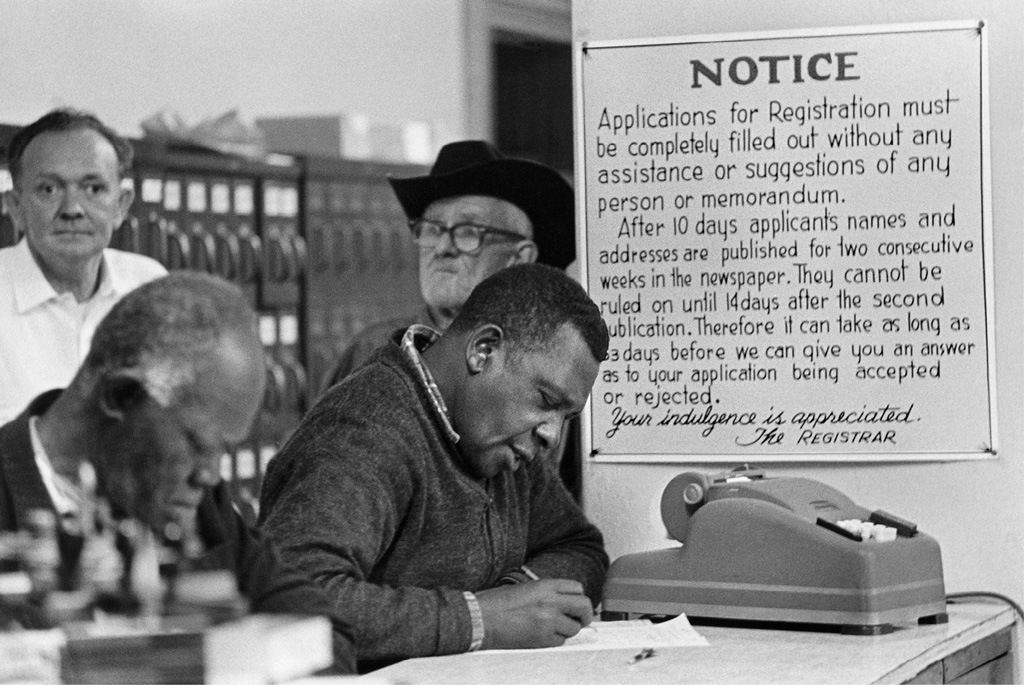 In January 1964 at a courthouse in Mississippi black applicants attempt to - photo 11