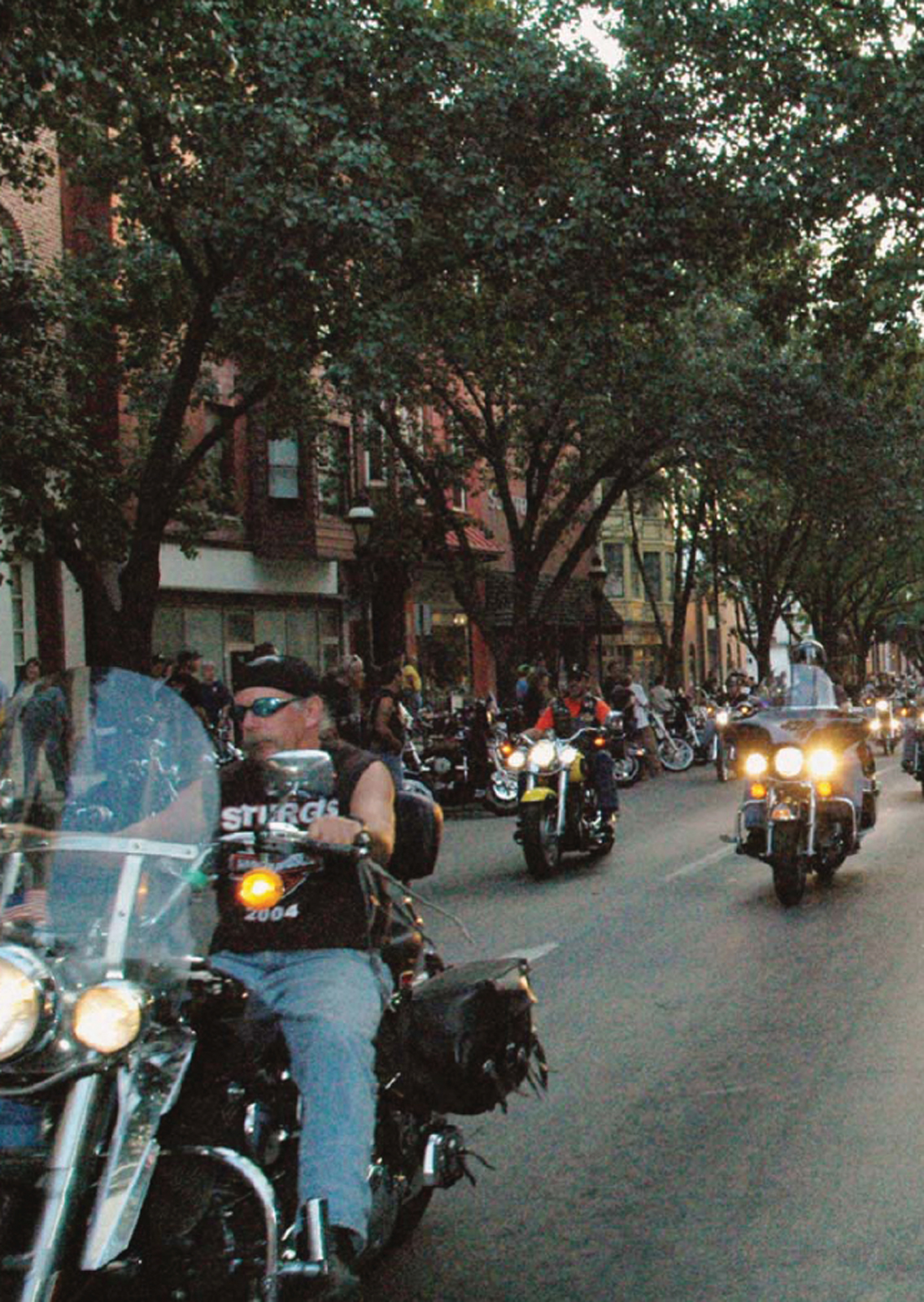 Motorcycles parade through the streets and past an appreciative audience of - photo 4