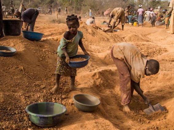 Four-year-old RasmataOuedraogo left and another child sort pans of soil for - photo 1