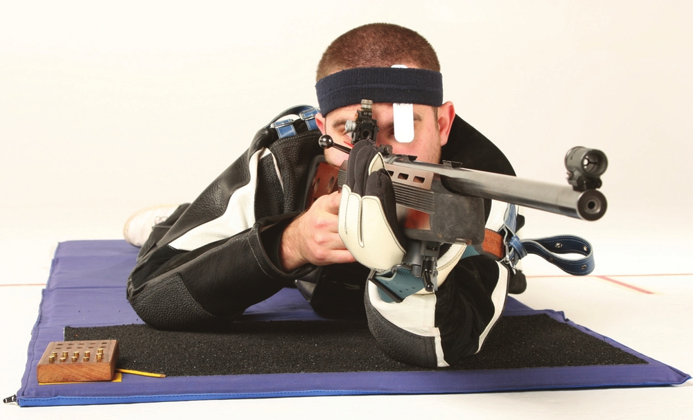 A small-bore rifle shooter wearing full prone position kit The book covers - photo 2