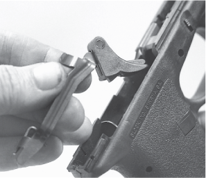 The trigger safety and the bar are both pivoted and retained in the trigger by - photo 21