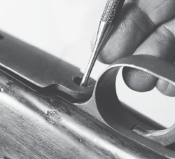 Remove the vertical screw on the underside at the front of the trigger guard - photo 6