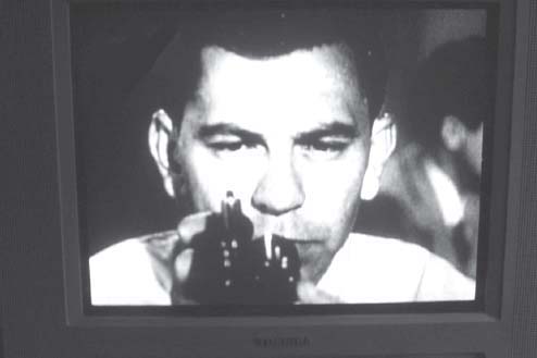 Jack Webb shown here checking his Colt Detective Special on an old Dragnet - photo 1