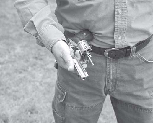 The gun should now be held by the top strap with your fingers serving to wedge - photo 5