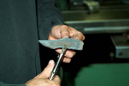 The author uses a vise clamp to attach the blade pattern to the damascus blade - photo 11