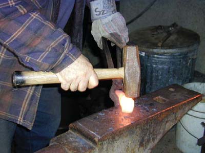 The author uses a gas forge to heat his steel billet before hammering it during - photo 6