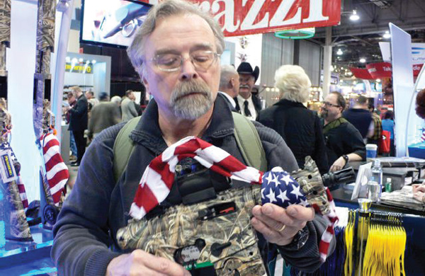 JAY CASSELL EXAMINES THE MOSSBERG 715P DUCK COMMANDER PISTOL AT THE 2014 SHOT - photo 2