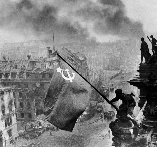 A Red Army soldier raises the flag of the Soviet Union in Berlin as Stalins - photo 3