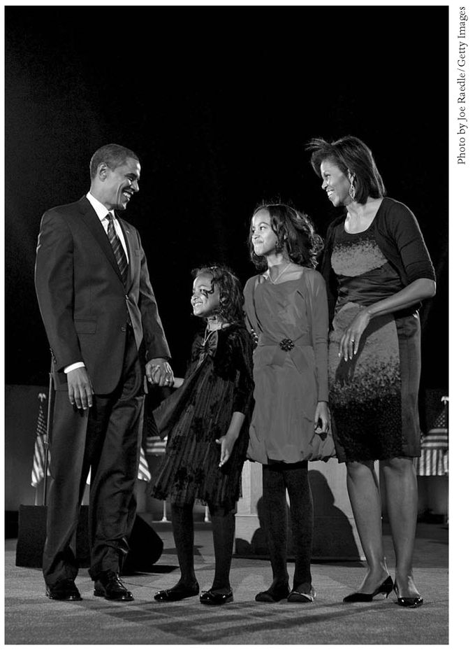 US President-elect Barack Obama stands onstage along with his wife Michelle - photo 3