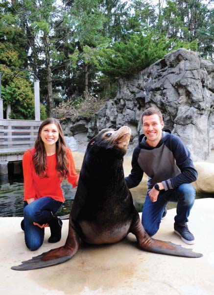 Bethanie and Josh Hestermann pose with Zuma a male California sea lion - photo 6
