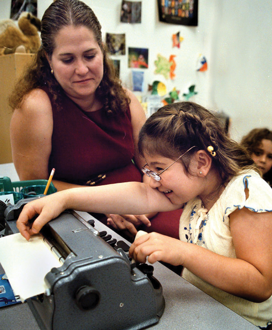 Image Credit ZUMA PressNewscom A teacher helps her student learn to use a - photo 4