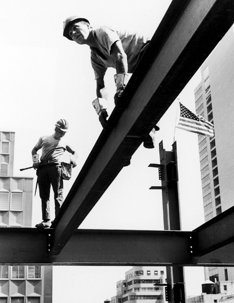 Ironworkers Jay Jacobs foreground and Sparky Rice working on a steel beam - photo 3