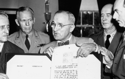 President Harry S Truman center holds up the document signed by the Japanese - photo 5