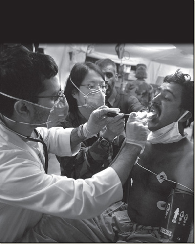 A diphtheria patient is examined by two American doctors at a Mobile Army - photo 18