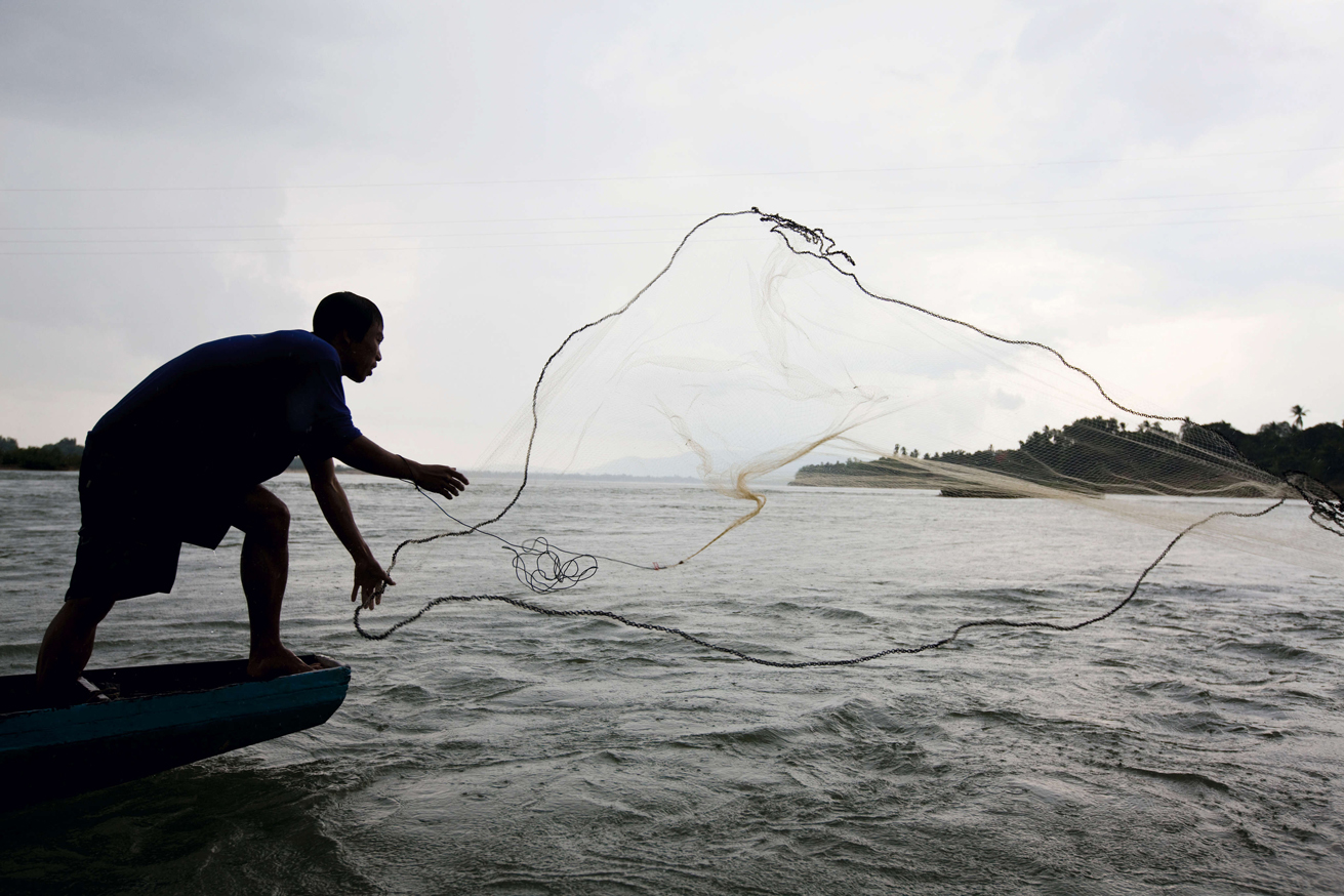 Fisherman casting his nets Peter StuckingsApa Publications Laos Cambodia - photo 7