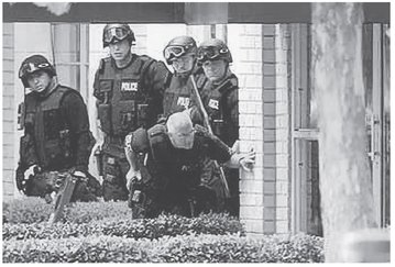 Members of a SWAT team hold a position during the hostage stand-off Courtesy - photo 15