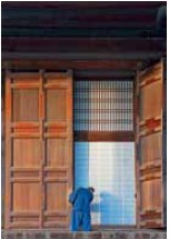 A Buddhist monk closes the great wooden doors that surround the Hondo main hall - photo 7