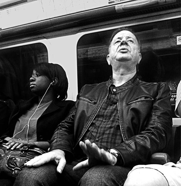 A passenger beats time with his hands The other passengers ignore him A black - photo 1