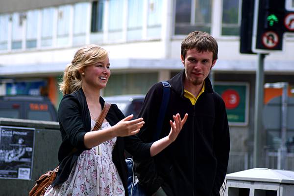 A young couple walk along the street she talking animatedly The camera was - photo 3