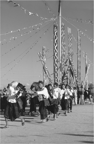 13 The Kachin dance in front of the manau posts at a manau festival honouring - photo 15