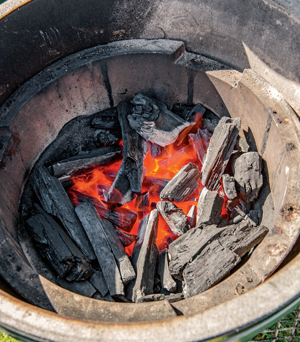 Unlit charcoal and smoking wood chunks Adding a plate setter Drip pan on - photo 8