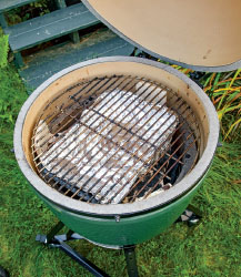 Drip pan on the plate setter and grid on top Make three divots in the charcoal - photo 11