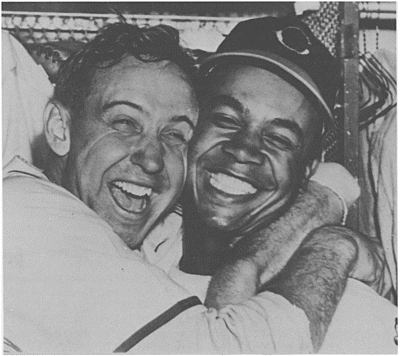 Celebrating in triumph Steve Gromek and Larry Doby embrace and laugh after the - photo 2