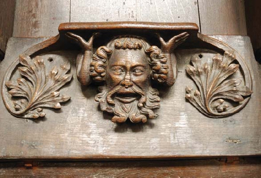 A man holds up the misericord and its occupant at Kings Lynn St Margaret - photo 8