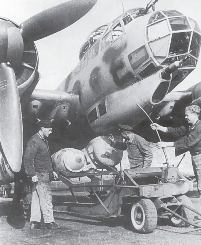 Ground crew use the outstanding hydraulic bomb trolley to load 1000 kg bombs on - photo 1