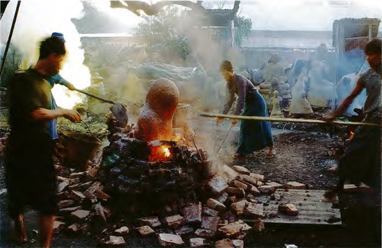 Artisans examine the mould of a Buddha image which has been fired in a - photo 4