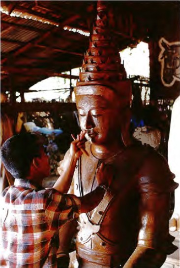 A master sculpts in the specific details of the Buddha images face after the - photo 5