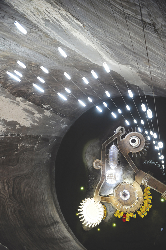 More than 350 feet below the surface rowboats bob on a lake inside Romanias - photo 2