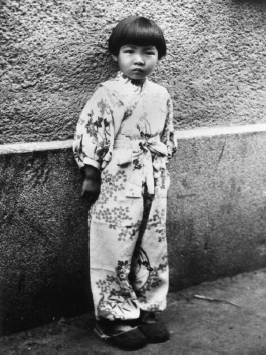 The author at age 5 standing beside the Shinkyo ether storehouse in Changchun - photo 1