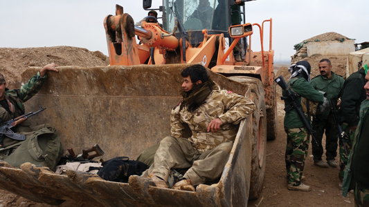 Loading our gear into the bucket of a truck at Tal al-Ward Peshmerga mobile - photo 13