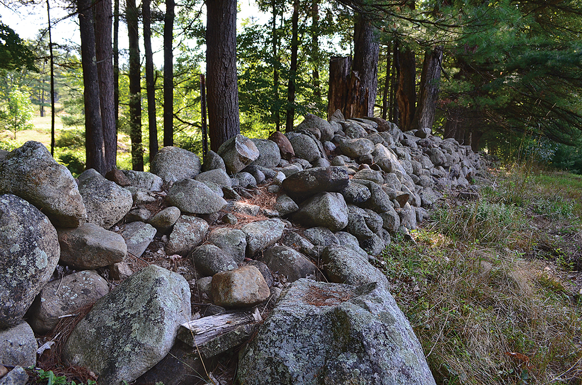 Antique fence posts and a stepped opening break this double-faced wall to give - photo 2