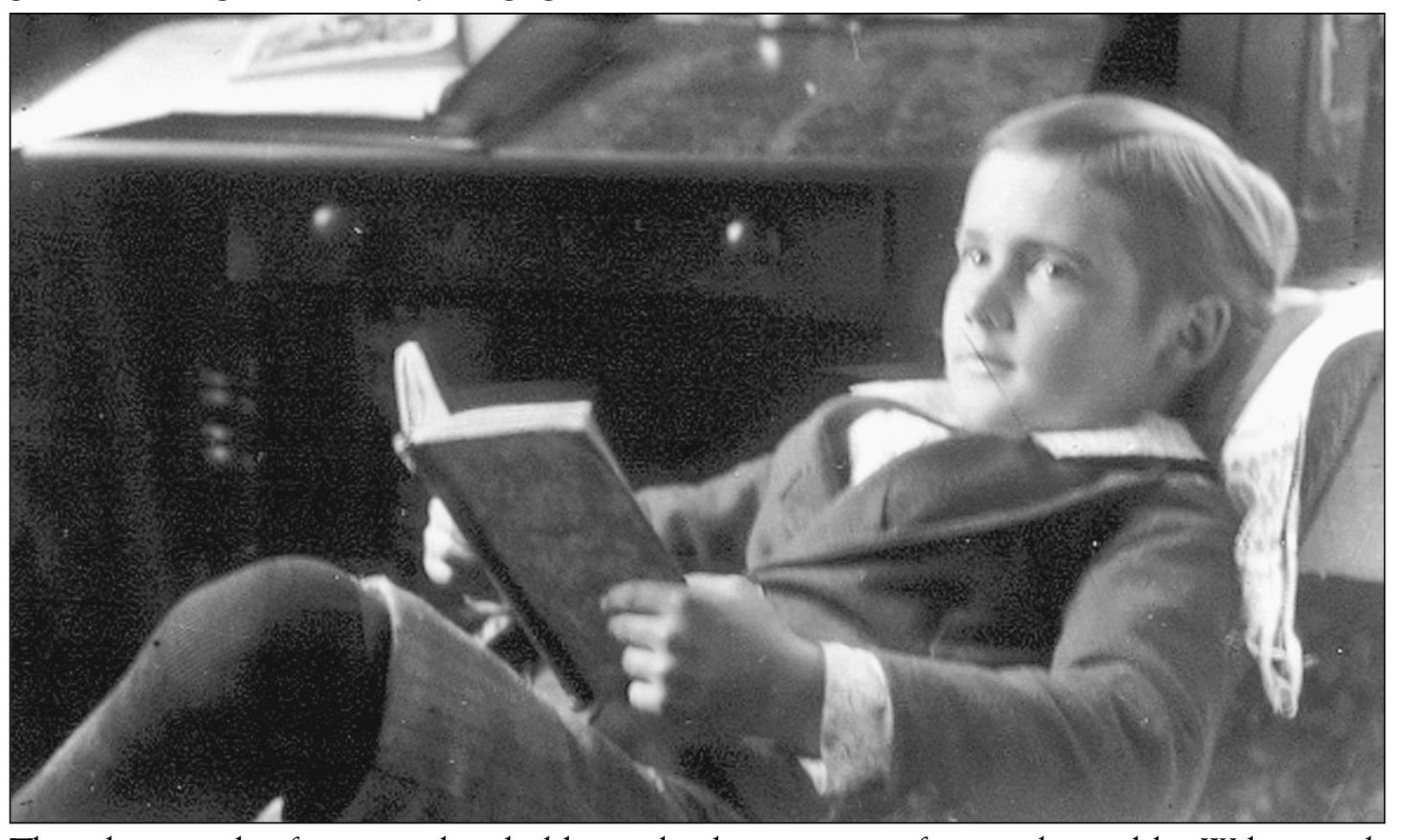 This photograph of a young boy holding a book was a pose frequently used by - photo 3