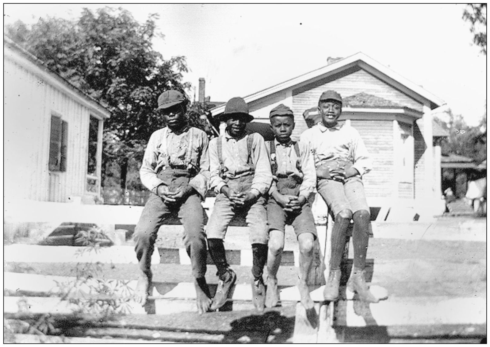 Wilsons photograph of four African-American boys sitting on a fence shares the - photo 4