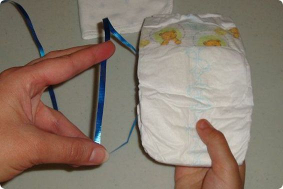 Grab the curling ribbon and one of the baby diapers Wrap the curling - photo 9